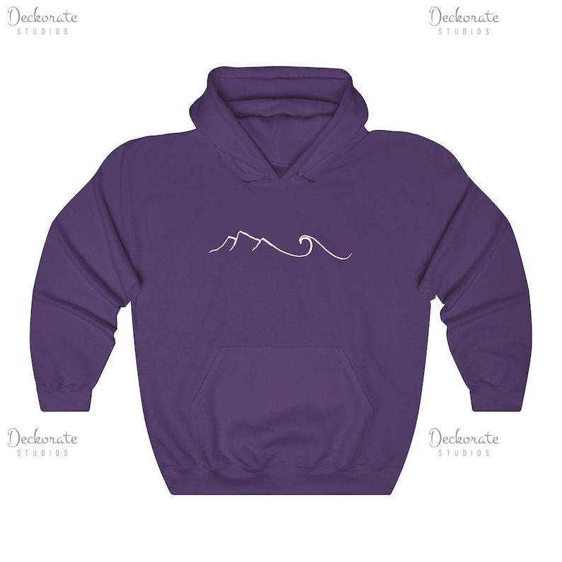 May include: A purple hooded sweatshirt with a front pocket and a white line drawing of mountains and waves. The sweatshirt has a drawstring hood and long sleeves. The design is centered on the chest.
