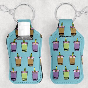 May include: A blue and white neoprene keychain bottle holder with a bubble tea pattern. The holder has a clear plastic bottle inside and a silver key ring. The text "Geekistngifts" is printed on the holder.