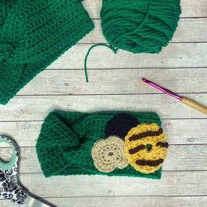 May include: Green crochet headband with a brown, yellow, and beige crocheted cookie design.
