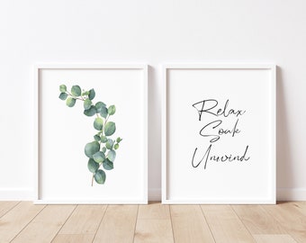 May include: Two white framed prints, one with a watercolour illustration of a eucalyptus branch and the other with the text "Relax Soak Unwind" in black calligraphy.
