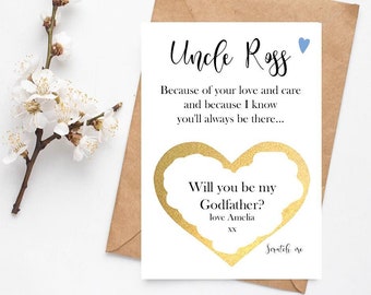 May include: A white card with gold foil accents and blue text. The card says "Uncle Ross" and "Will you be my Godfather?" with a gold foil heart shape around the text. The card is on a brown envelope.