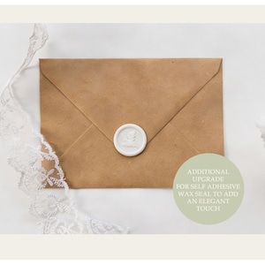 A light brown envelope with a white wax seal on the flap, resting on a white lace ribbon.
