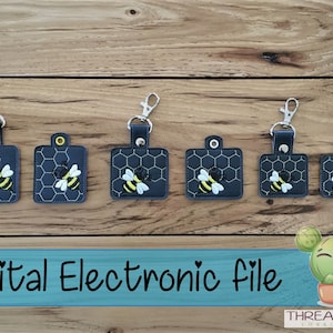 May include: Five different sizes of keychains featuring a bee on a honeycomb design. The keychains are made of black fabric with a silver metal ring. The text "Digital Electronic File" is displayed at the bottom of the image.