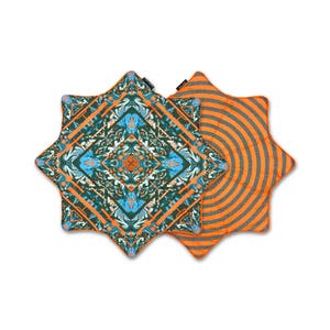 May include: Two star-shaped cushions with distinct patterns. One features a complex geometric design in shades of teal, blue, and orange. The other displays a pattern of concentric orange and dark grey circles. Both have orange piped edges.