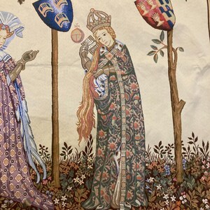May include: A tapestry depicting a medieval scene with three figures. The central figure is a woman wearing a crown and a long, patterned robe. She is holding a book and a long, flowing strand of hair. The figures are standing in a garden setting with trees and flowers.