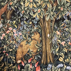 May include: A tapestry depicting a fox in a forest setting. The fox is brown and white and is standing in front of a large tree. The forest is filled with green leaves and flowers in shades of pink, red, and blue.