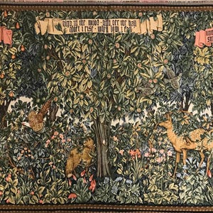 May include: A tapestry depicting a forest scene with trees, flowers, and animals. The tapestry features two banners with text: "In this wood - high over the hall -  I mart - I must - I will - I call" and "How often I stand - what would I give -  to smile sweetly -  the world I do".