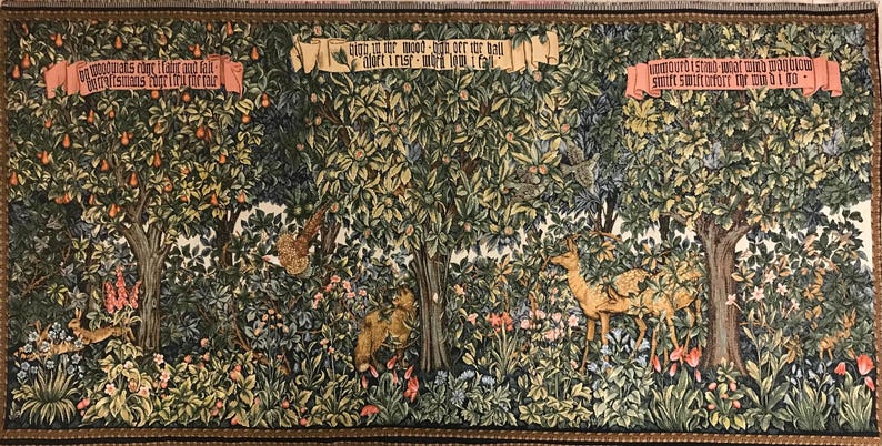 May include: A tapestry depicting a forest scene with trees, flowers, and animals. The tapestry features two banners with text: "In this wood - high over the hall -  I mart - I must - I will - I call" and "How often I stand - what would I give -  to smile sweetly -  the world I do".