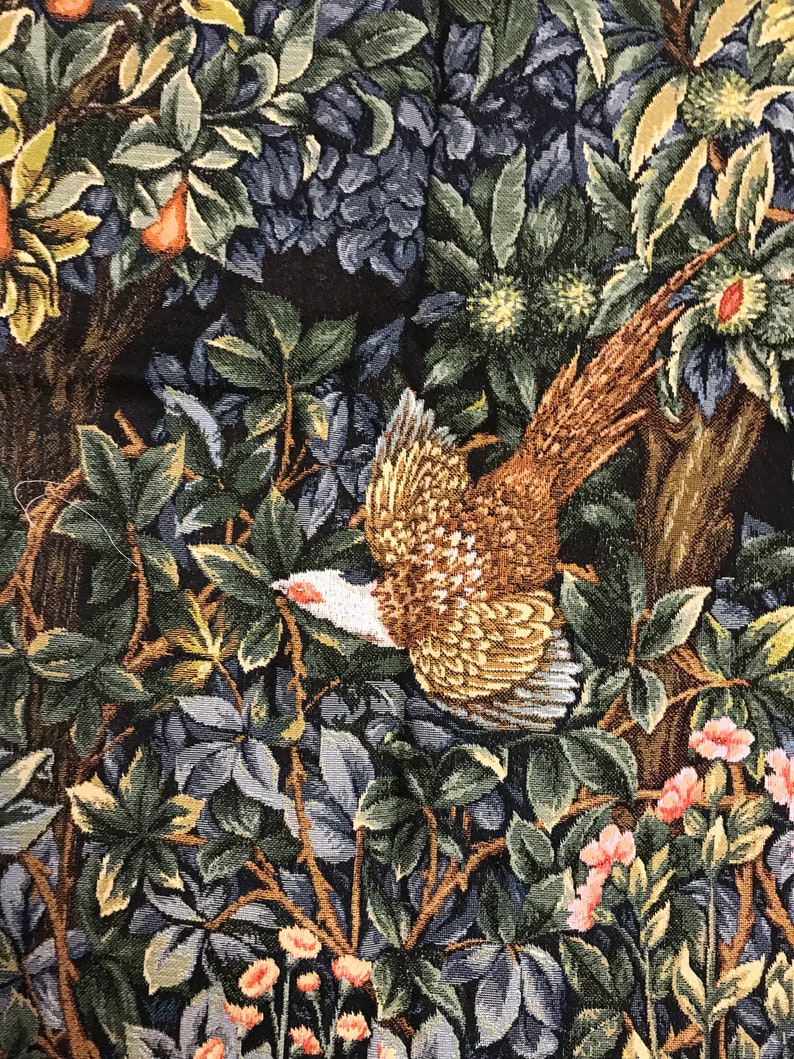 May include: A tapestry featuring a pheasant in flight, surrounded by lush green and blue foliage. The pheasant is brown, gold, and white with a long tail. The background is a dark brown.