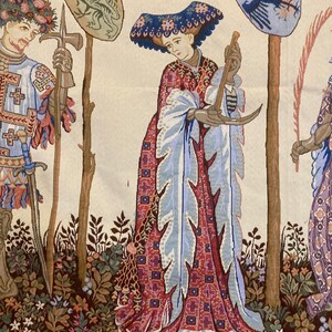May include: A tapestry depicting a scene from medieval times. A woman in a blue and red dress holds a crescent moon in her hands. A man in armor stands to the left, holding a sword and a shield with a dragon on it. A tree with a shield featuring a bird is in the background.