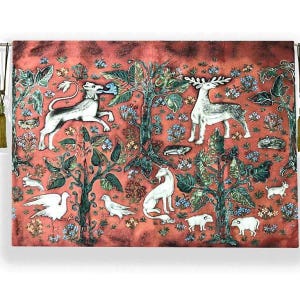 May include: A tapestry with a red background featuring a variety of animals and plants. The animals include a unicorn, a deer, a lion, and a bird. The plants are green and leafy, and there are also some flowers.