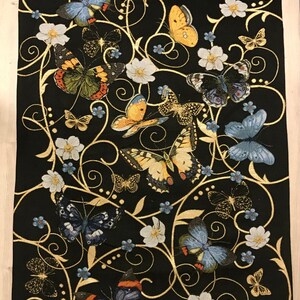 May include: Black tapestry featuring a repeating pattern of gold swirls and butterflies in various colors, including yellow, blue, and orange. The butterflies are surrounded by small white flowers.
