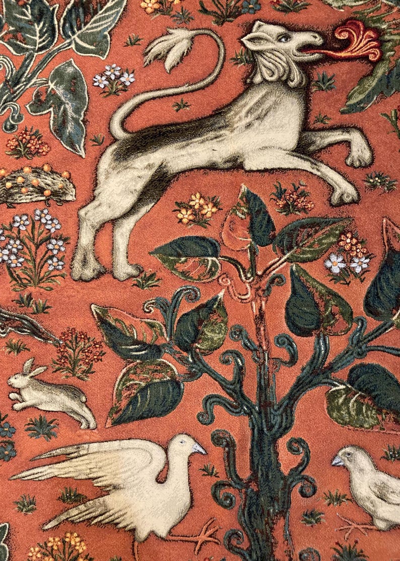 May include: A tapestry featuring a white lion with a red flame coming out of its mouth, surrounded by green leaves and flowers on a red background.