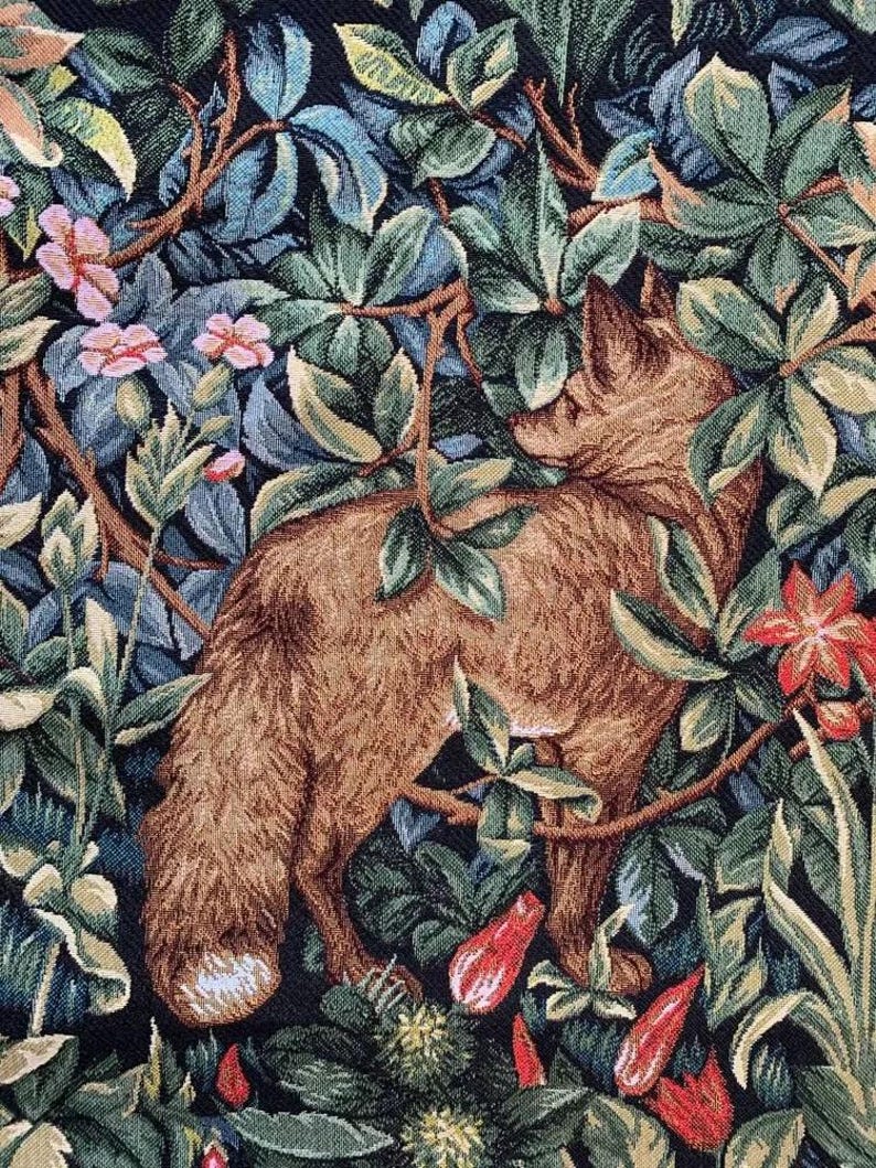 May include: A tapestry featuring a brown fox standing in a lush green forest with red and pink flowers. The fox is surrounded by leaves and branches, creating a sense of depth and detail.
