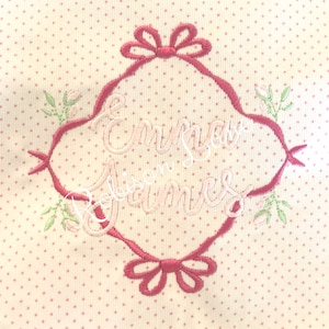 May include: Pink embroidered design with a decorative frame and the names "Emma" and "Robinson James" on a white background with pink polka dots.