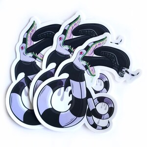 May include: Three black and white striped stickers with a purple and green creature with a large mouth and sharp teeth. The creature is depicted with a black and white striped body and a green tongue.