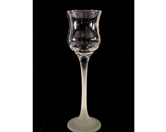 May include: A clear glass stemmed shot glass with a frosted base. The glass has a wide, rounded bowl and a long, slender stem.