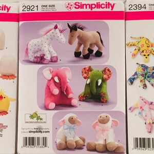 May include: Three Simplicity sewing patterns for making stuffed animals. The patterns are for a unicorn, horse, elephant, lamb, chick, bunny, bear, and octopus. The patterns are all one size and are available at Joann Fabrics.