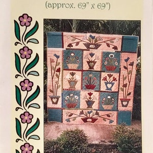 May include: A quilt pattern for a quilt titled "Sticks & Stones in Flannel" with a floral design in shades of pink, blue, and green. The quilt is approximately 69 inches by 69 inches.