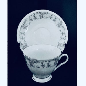 Porcelain China Dainty Cup and Saucer - Lavender Flowers and Pale Green Leaves on a White Background with Gold Trim - Giftable