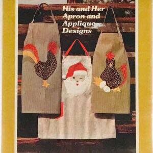 May include: Two patchwork apron patterns with instructions. The patterns feature applique designs of a rooster, Santa Claus, and a hen. The text on the package reads "His and Her Apron and Applique Designs".