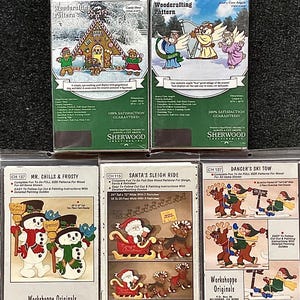 May include: Six woodcraft patterns featuring holiday themes. The patterns include a gingerbread house, angels playing a harp, snowmen, Santa's sleigh, and skiers. Each pattern includes instructions for cutting and painting.