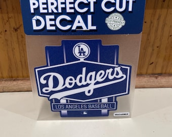 May include: A blue and white Los Angeles Dodgers decal with the team's logo and the words "Dodgers" and "Los Angeles Baseball".