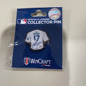 May include: Officially licensed collector pin featuring a white baseball jersey with the number 17 and the name "Ohtani" on the back. The pin is made by WinCraft, by Fanatics.