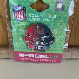 May include: A collectible lapel pin featuring the logos of the Kansas City Chiefs and the Philadelphia Eagles, the teams that played in Super Bowl LIX. The pin is silver with red, green, and gold accents. The score of the game, 22-40, is printed on the pin. The pin is officially licensed by the NFL.