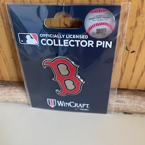 May include: Officially licensed collector pin featuring a red and silver Boston Red Sox "B" logo on a blue background. The pin is packaged on a card with the WinCraft logo.