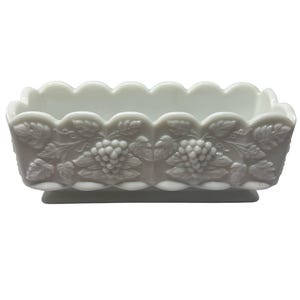 May include: White milk glass rectangular dish with a scalloped rim and grapevine design.
