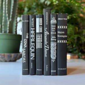 May include: A set of six black hardcover books with white text titles. The titles are "The Star Sailors", "West Harlequin", "Terminal", "Alexandre Dumas", "Too Far To Walk", and "Marjorie Morningstar".