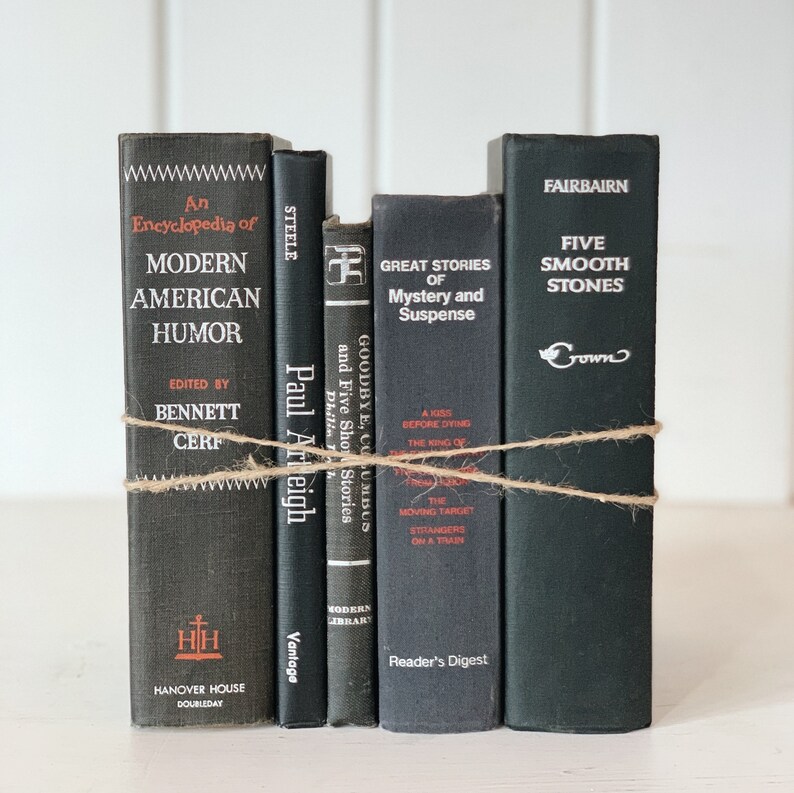 May include: A collection of vintage books with dark covers, tied together with twine. Titles include "An Encyclopedia of Modern American Humor," "Great Stories of Mystery and Suspense," and "Five Smooth Stones."