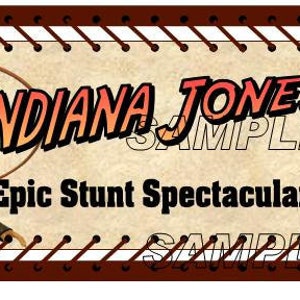 May include: A brown and white vintage-style ticket with a red stitched border. The ticket features a cartoon image of Indiana Jones holding a whip and the text "Indiana Jones Epic Stunt Spectacular!"
