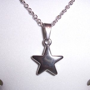 May include: A silver chain necklace with a silver star pendant.