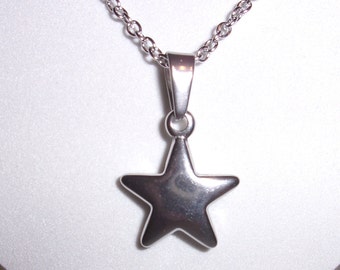 May include: A silver chain necklace with a silver star pendant.