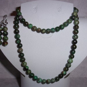 May include: A green and brown turquoise stone necklace and matching earrings. The necklace is made of round beads and is approximately 18 inches long.