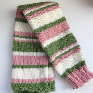 May include: Striped knitted leg warmers in pink, white, and green.