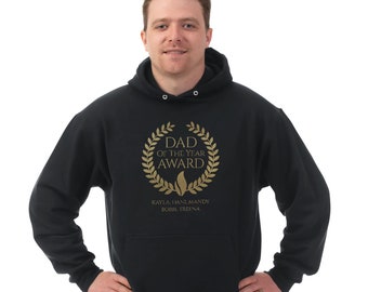 May include: Black hooded sweatshirt with a gold graphic that says "Dad of the Year Award" with a laurel wreath around the text. The names Kayla, Dani, Mandy, Bobbi, and Treena are printed below the graphic.