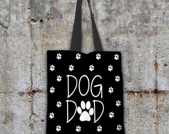 May include: Black tote bag with white paw print pattern and the text "DOG DAD" in white.
