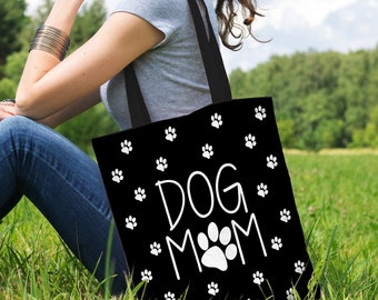 May include: A black tote bag with white paw prints and the text "DOG MOM".