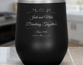 May include: Black stainless steel wine tumbler with a silver lid and engraved text that reads "Judi and Mike Drinking Together Since 1988".