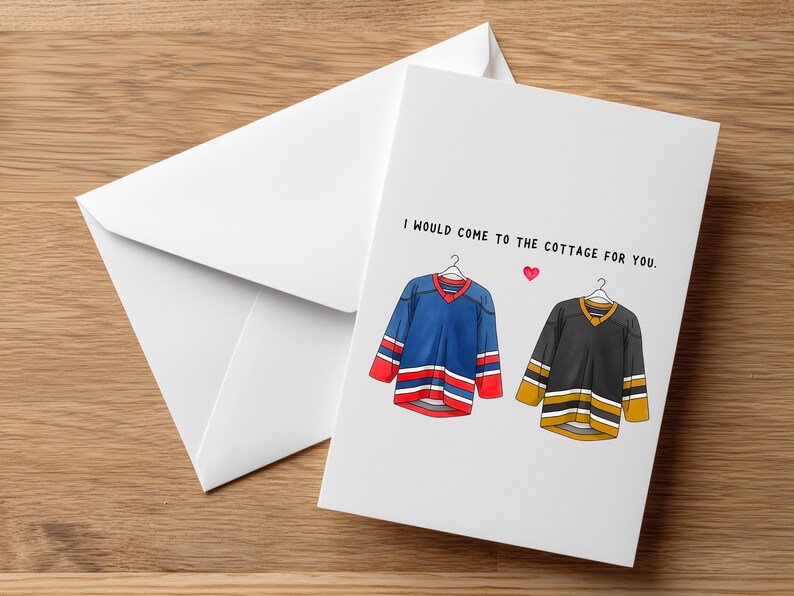 May include: A white greeting card with a matching envelope. The card features illustrations of two hockey jerseys, one blue and one black, with the text "I would come to the cottage for you."