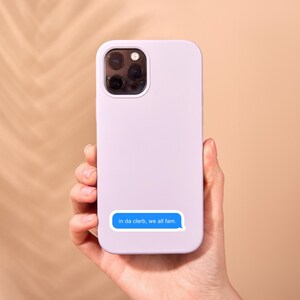May include: A lavender phone case with a blue text message sticker that reads "in da cleb, we all fam."