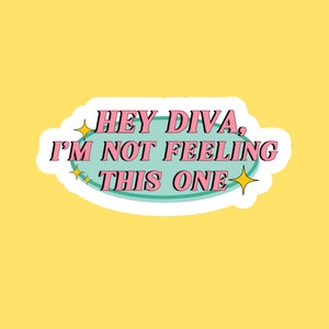 May include: A teal blue oval sticker with a white border. The sticker has pink text that reads "Hey Diva, I'm not feeling this one." There are two yellow stars on either side of the text.