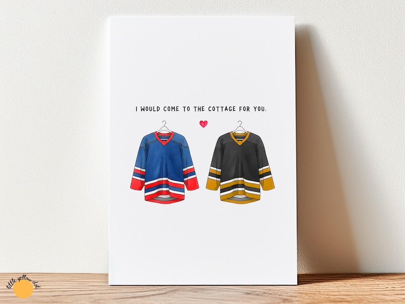 May include: A white card with the text "I would come to the cottage for you." features illustrations of two hockey jerseys and a pink heart. One jersey is blue with red and white accents, the other is black with gold and white accents.