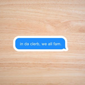 May include: A blue text message bubble on a wood background with the text "in da clerb, we all fam."