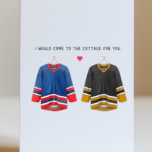 May include: Illustration of two hockey jerseys hanging on a light blue background. One jersey is blue with red and white stripes, the other is black with gold and white stripes. The text reads, "I would come to the cottage for you."