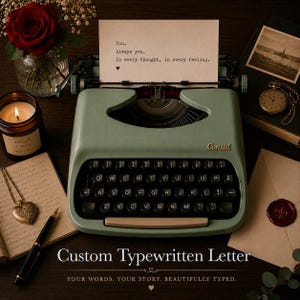 May include: A sage green Consul typewriter with black keys and a paper sheet featuring the text: You. Always you. In every thought, in every feeling. The typewriter is surrounded by a red rose, a candle, a heart-shaped locket, and a fountain pen.