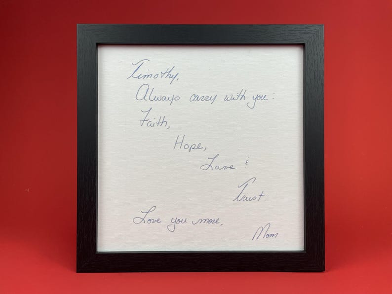 Black framed handwritten message addressed to Timothy and signed Mom, displayed against a red background.